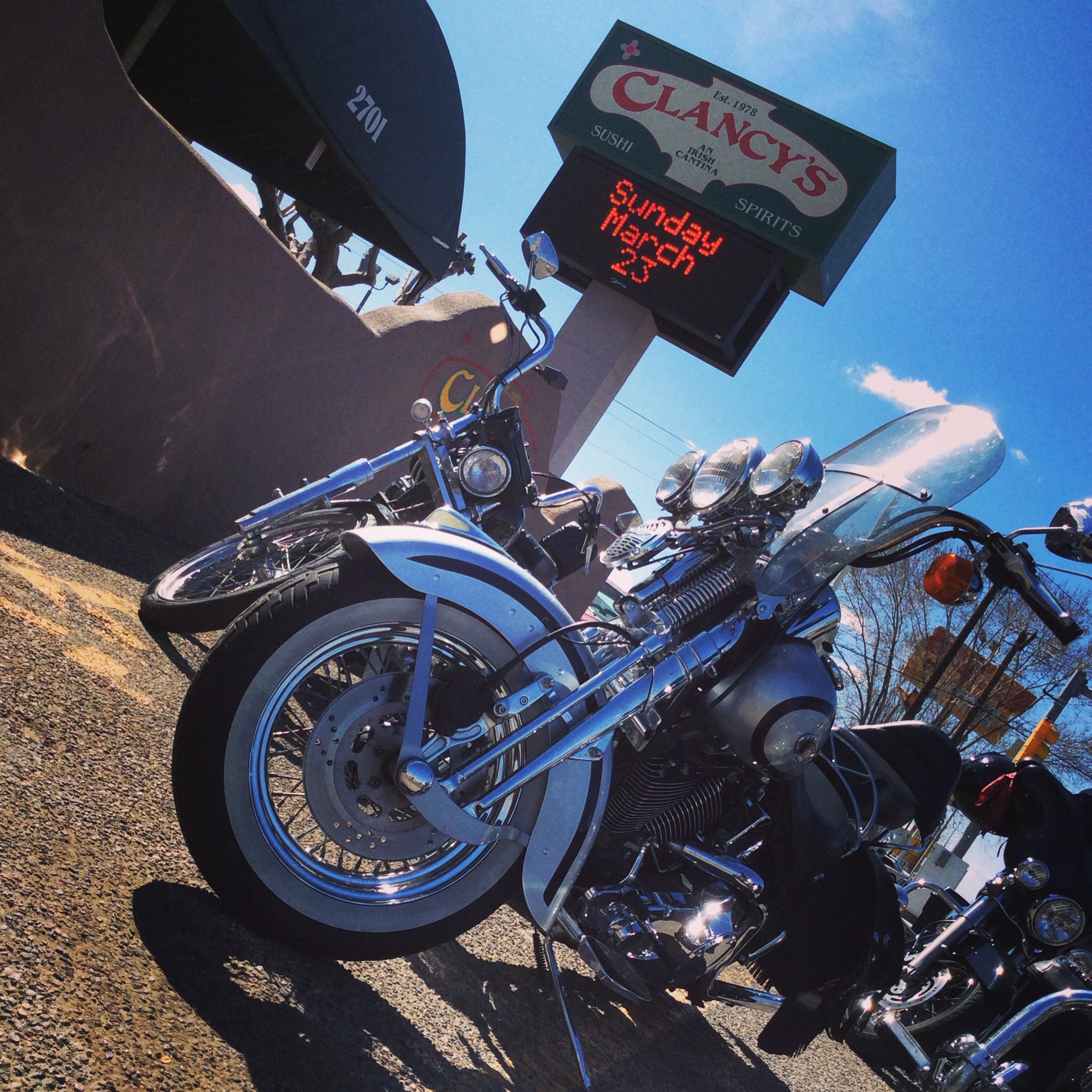 Clancy's exterior sign and motorcycles at 2701 E 20th